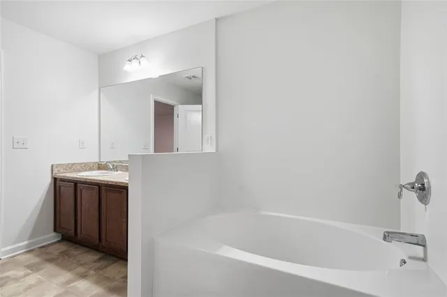 a bathroom with a bathtub and a sink