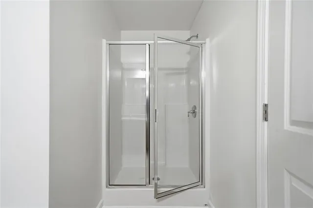 a bathroom with a glass shower door