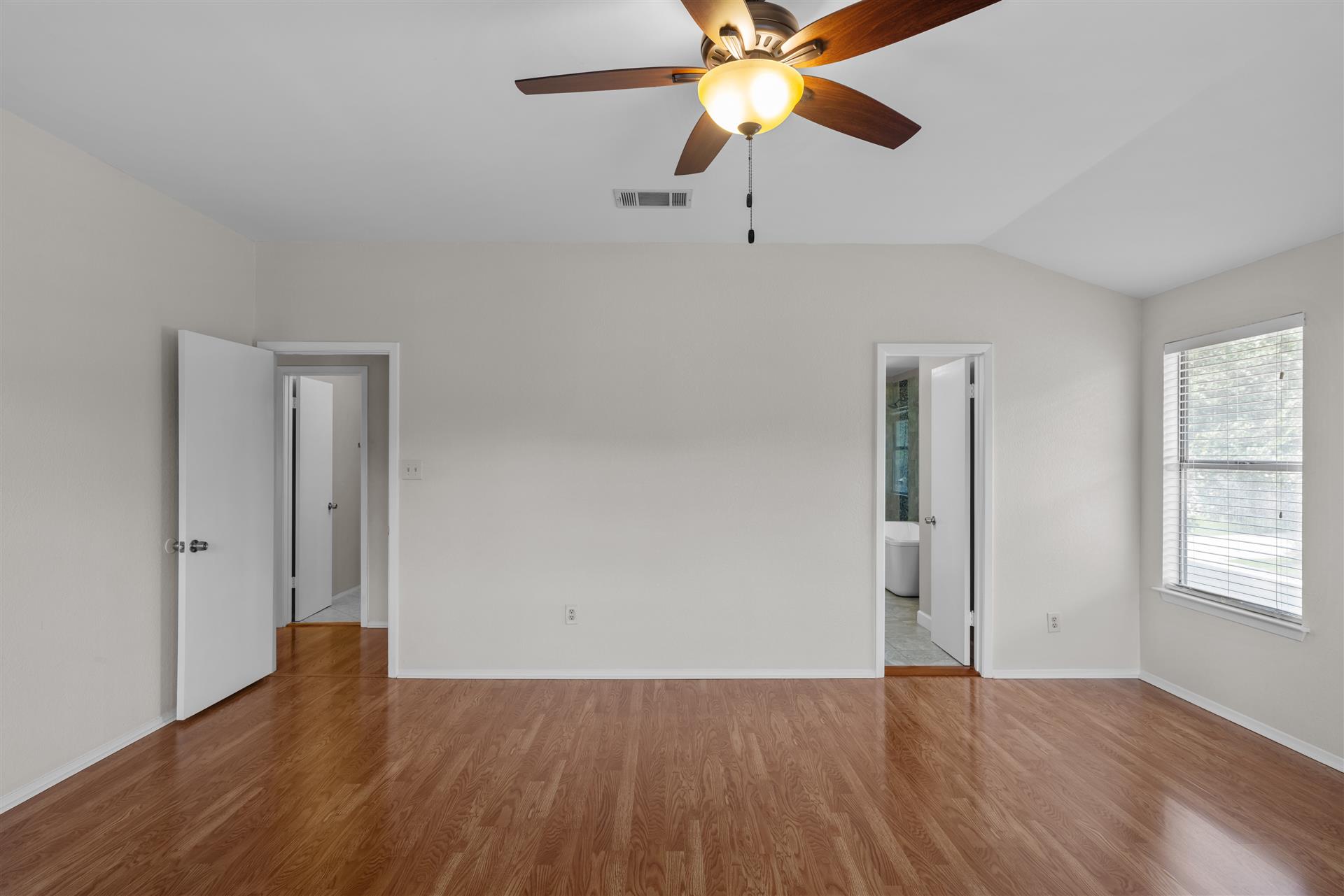 1710 Persimmon Road Cedar Park, TX 78613 - Photo 20 of 33 The primary bedroom includes a vaulted ceilings and ensuite spa bathroom.