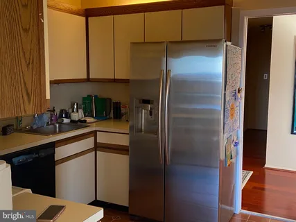 a kitchen with a refrigerator and a sink