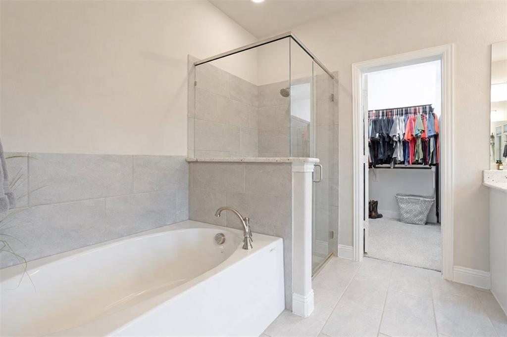 1205 Redbud Street Howe, TX 75459 - Photo 17 of 40 a bathroom with a tub and a shower