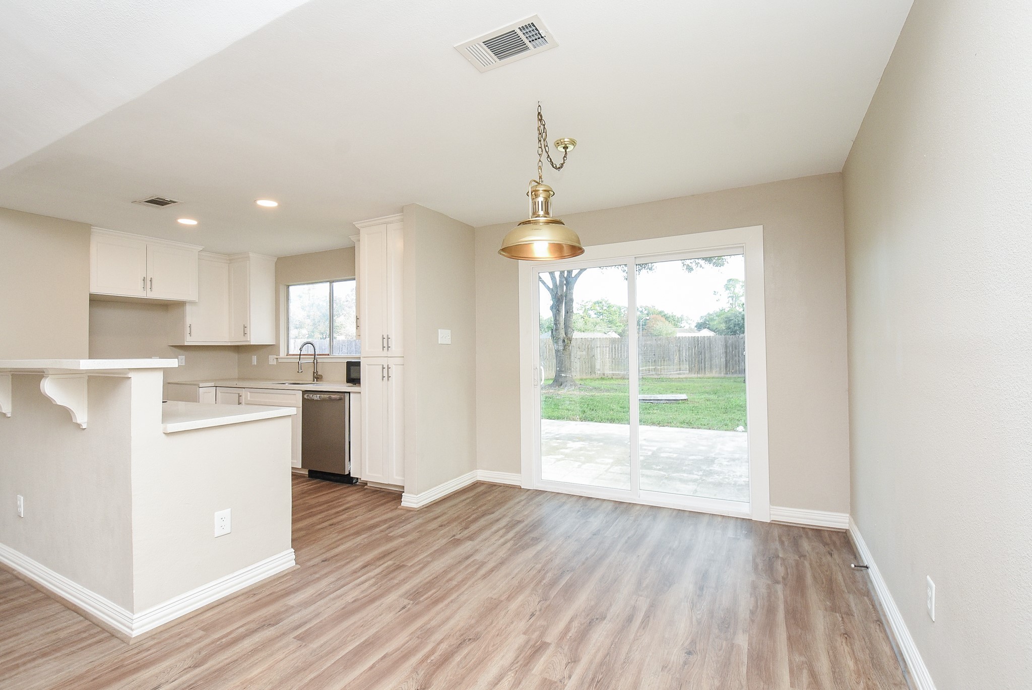 4606 Whispering Rock Lane Spring, TX 77388 - Photo 12 of 30 a open kitchen with white cabinets and wooden floor