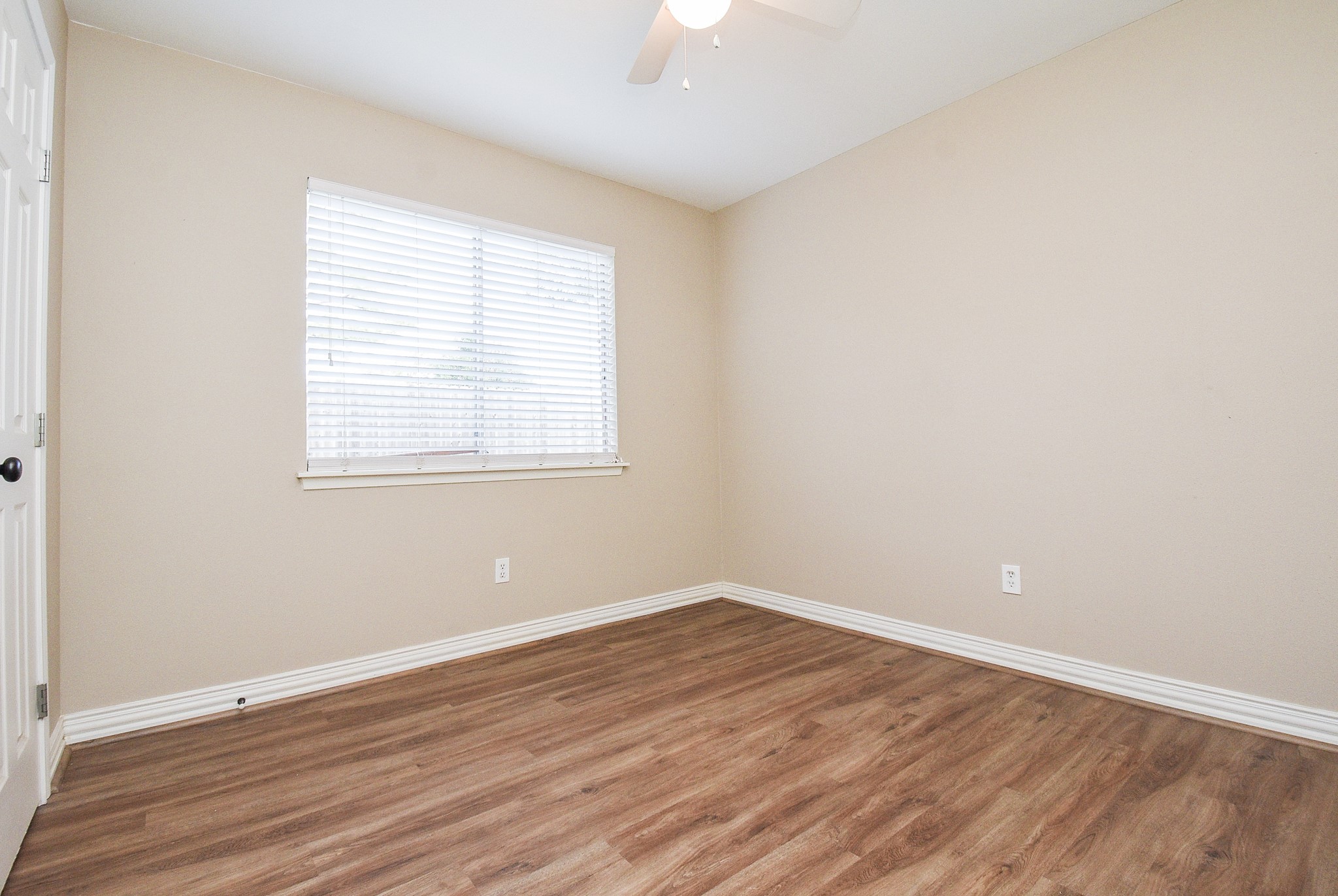 4606 Whispering Rock Lane Spring, TX 77388 - Photo 21 of 30 an empty room with wooden floor and windows