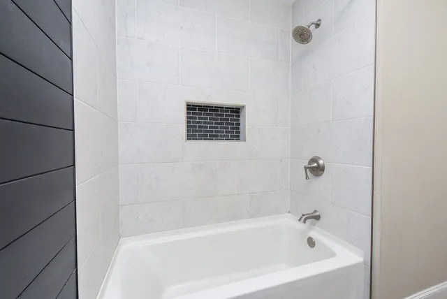 a view of a house with backyard and a tree