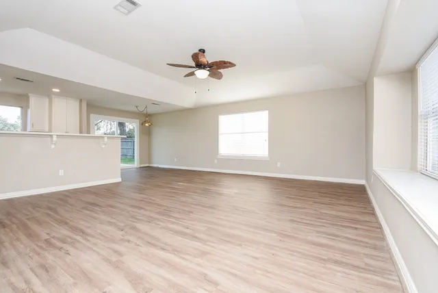 wooden floor in an empty room with a window