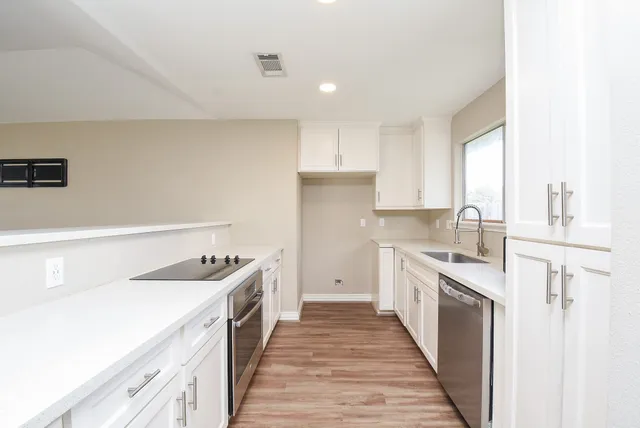 a kitchen with a sink stove and refrigerator