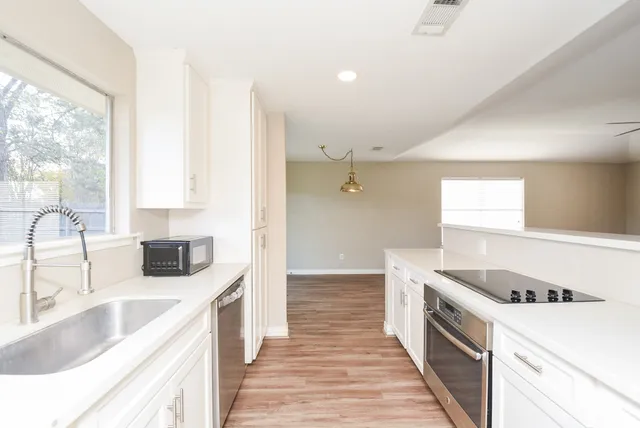 a kitchen with a stove a sink and a refrigerator