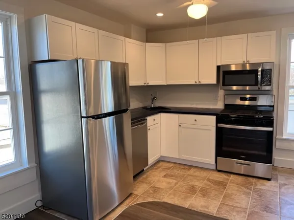 a kitchen with a refrigerator and a stove