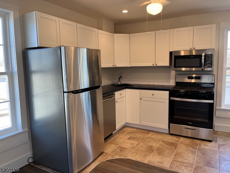 15 Summit Avenue, Unit B Chatham, NJ 07928 - Photo 3 of 4 a kitchen with a refrigerator and a stove