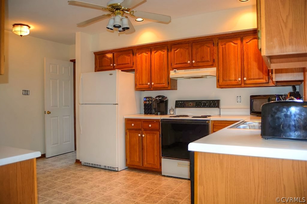 11715 Winterpock Road Chesterfield, VA 23838 - Photo 18 of 21 a kitchen with a refrigerator a stove and a sink