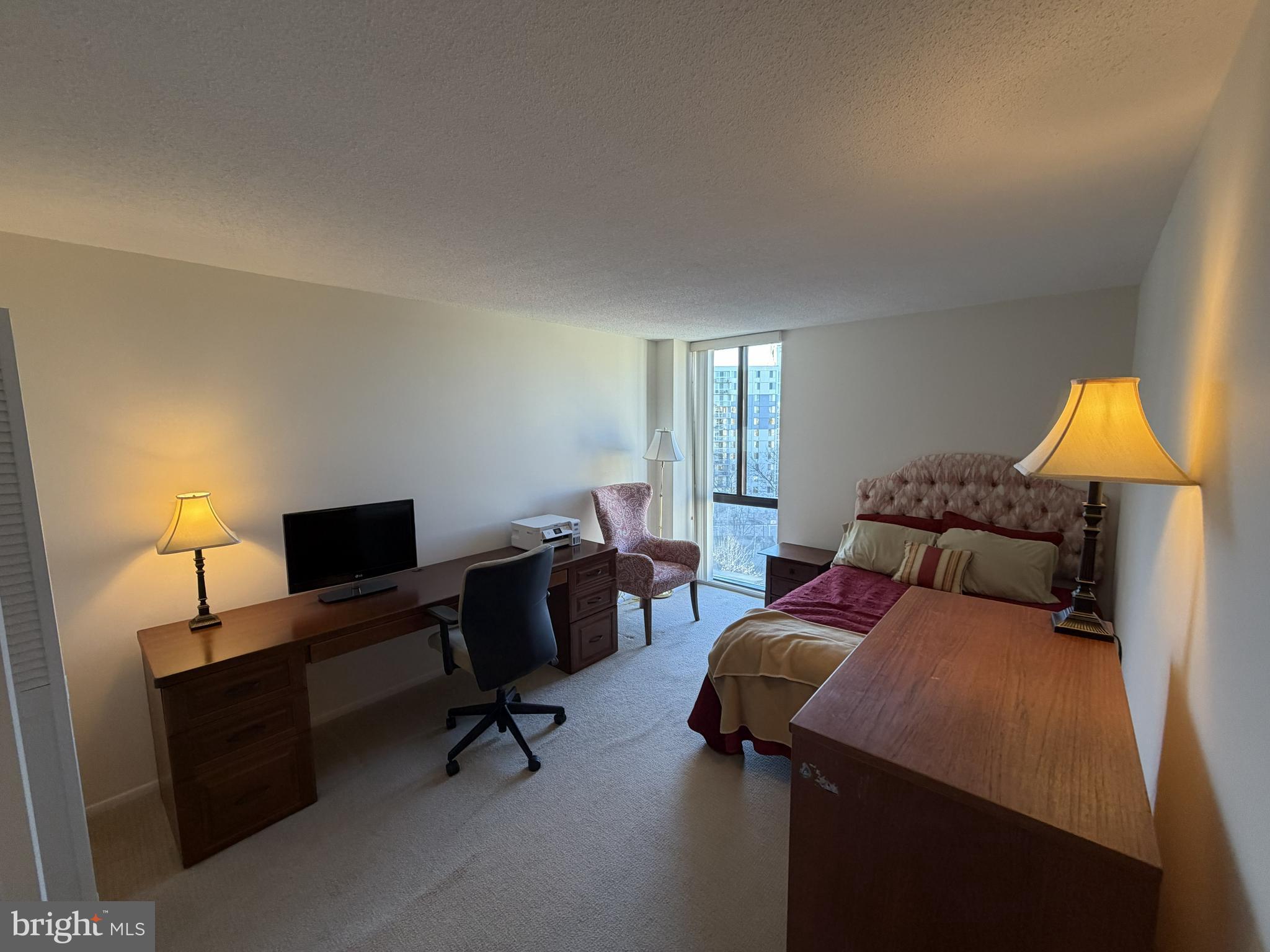 6800 Fleetwood Road, Unit 1002 McLean, VA 22101 - Photo 13 of 22 a bedroom with a bed and a lamp
