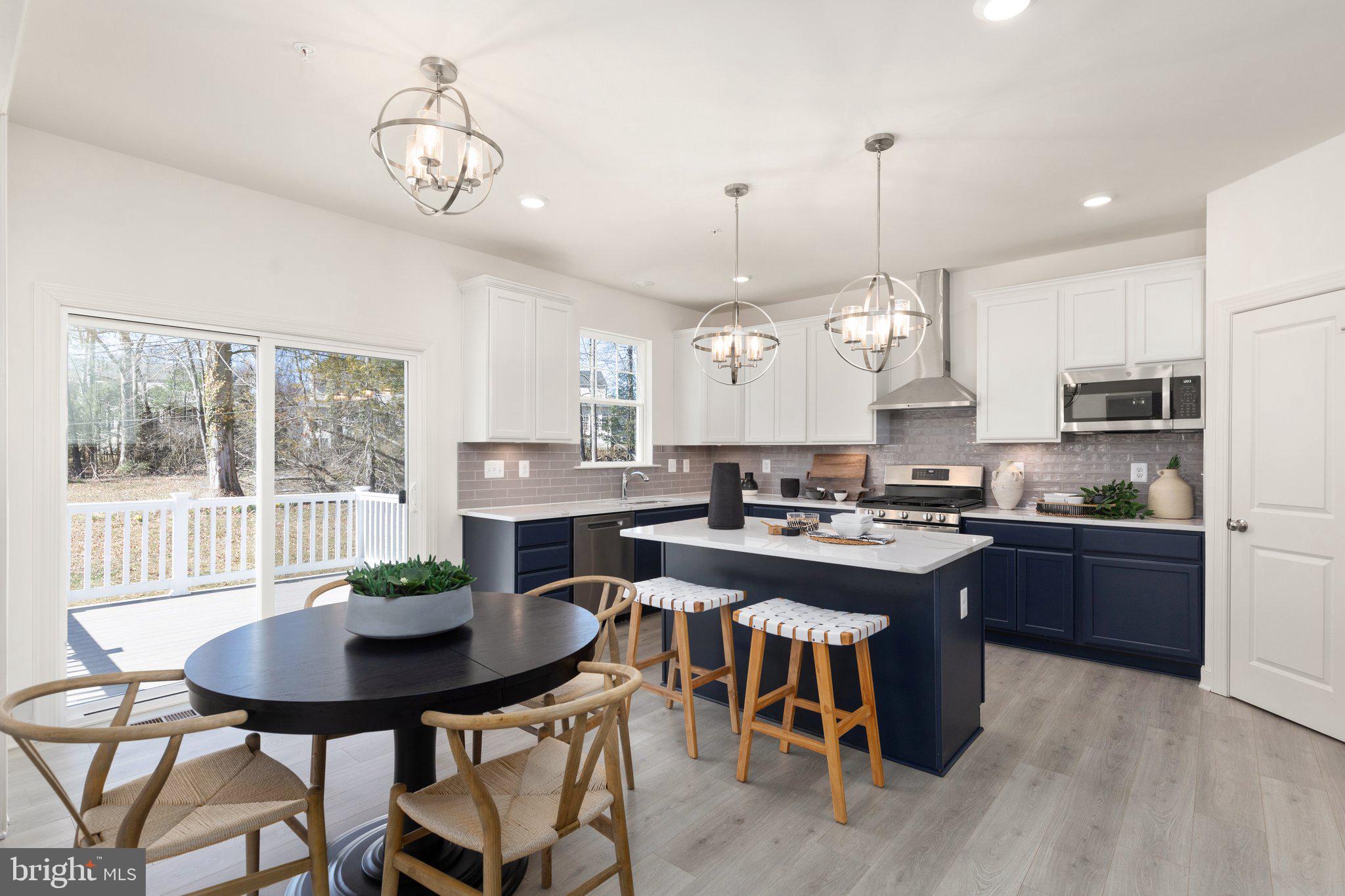 529 C Trimble Road Joppa, MD 21085 - Photo 16 of 26 a kitchen with stainless steel appliances granite countertop a stove a sink a refrigerator a dining table and chairs