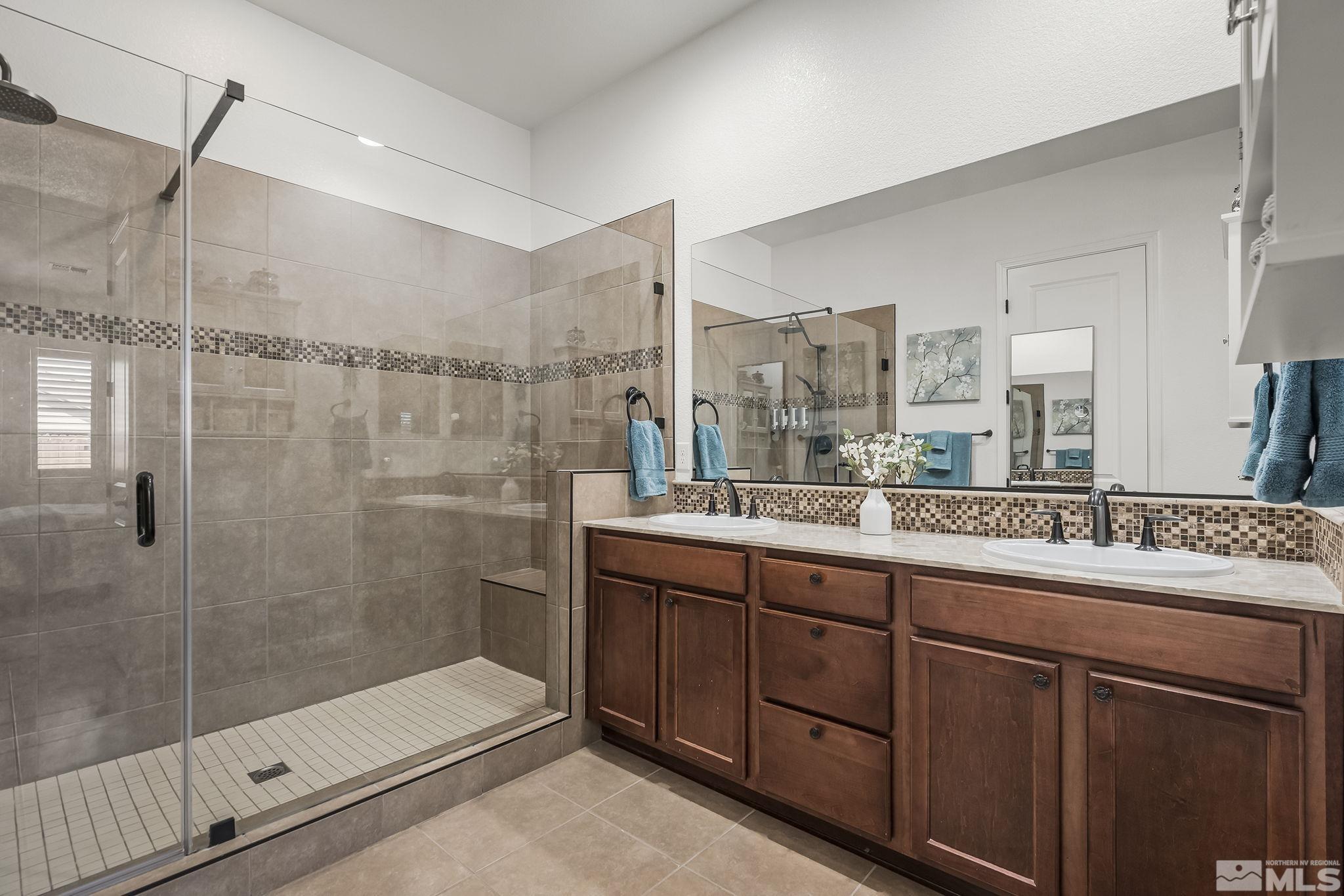 2215 Trakehner Lane Reno, NV 89521 - Photo 13 of 23 a bathroom with a granite countertop sink mirror and shower
