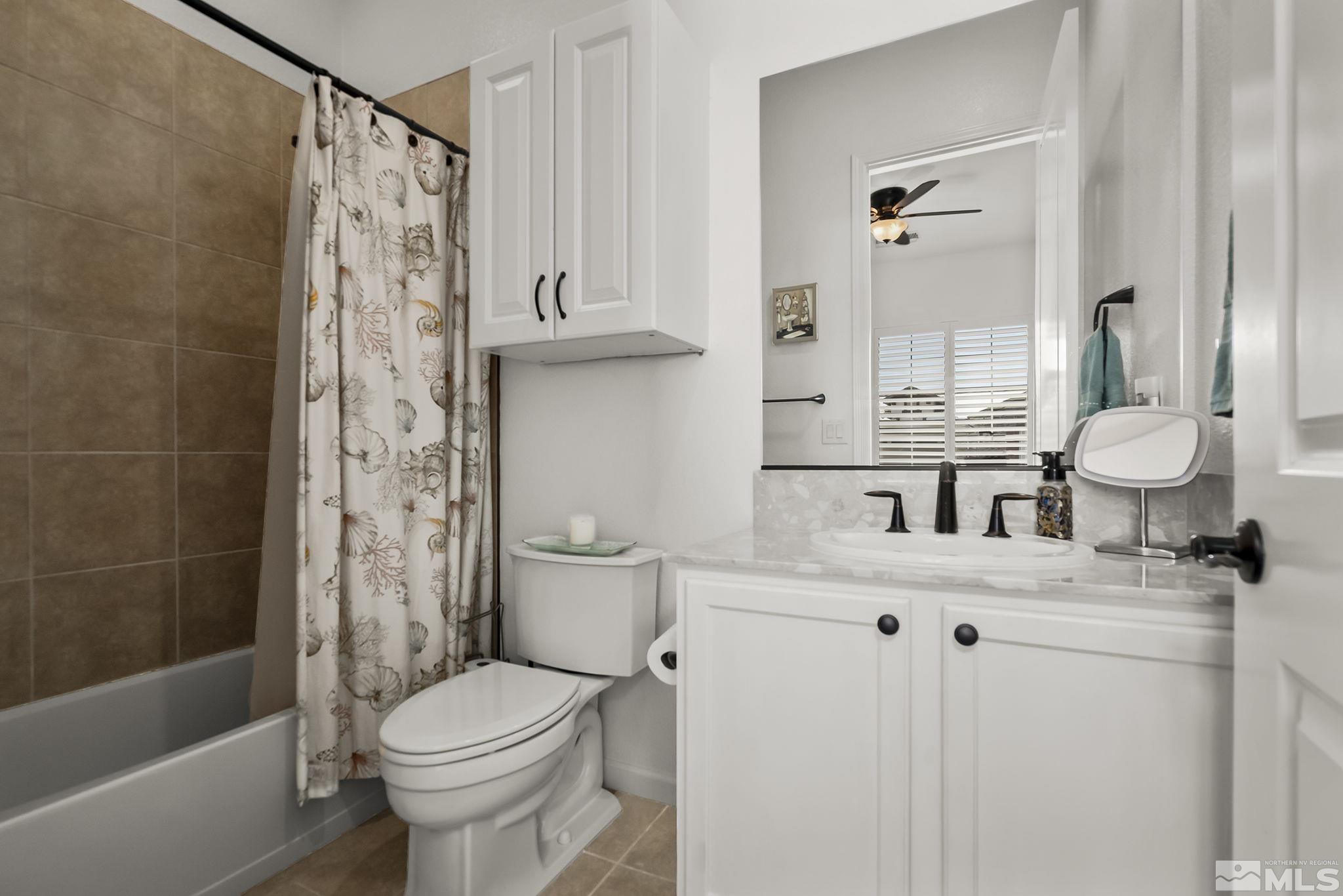 2215 Trakehner Lane Reno, NV 89521 - Photo 17 of 23 a bathroom with a sink a toilet and shower