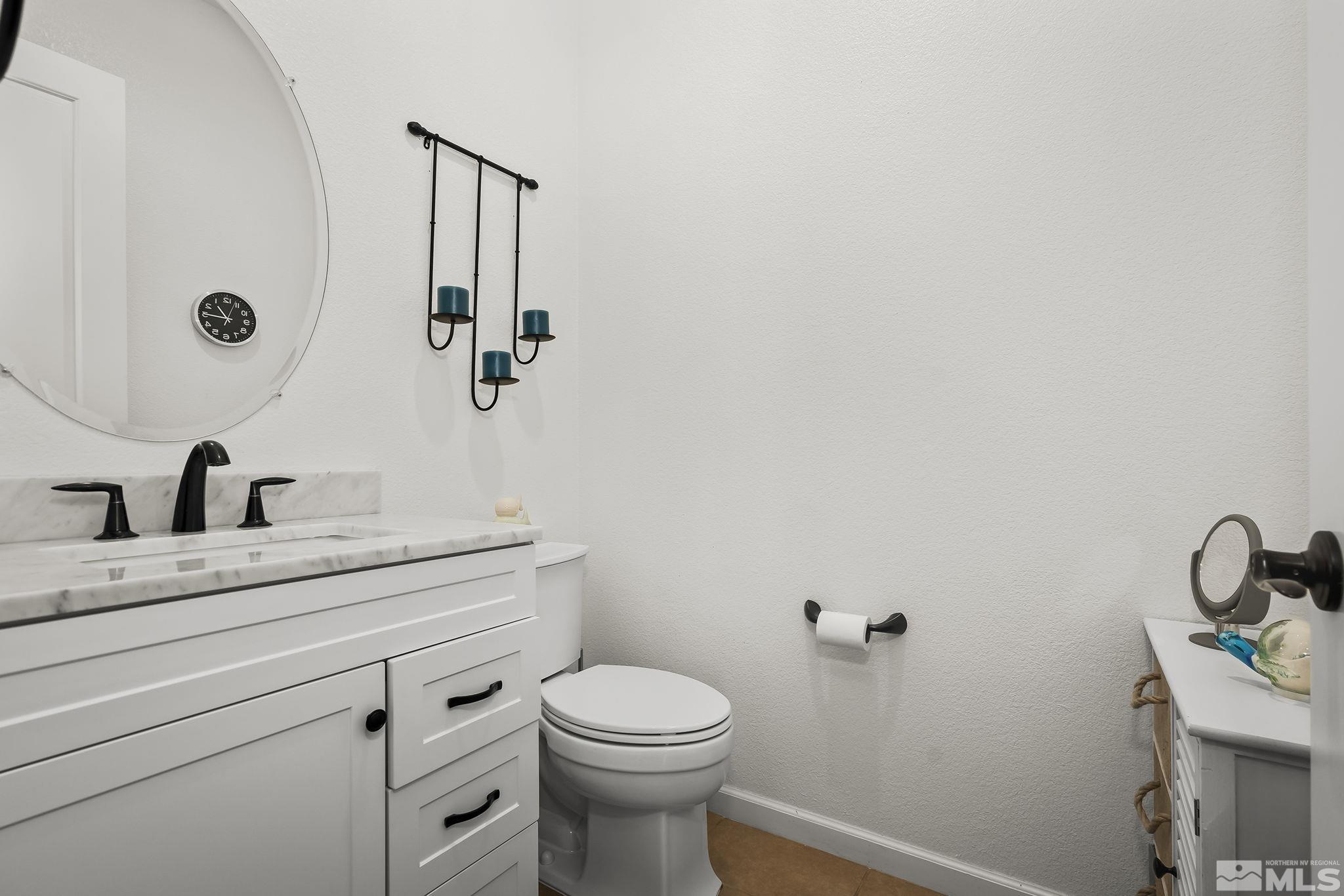 2215 Trakehner Lane Reno, NV 89521 - Photo 18 of 23 a bathroom with a granite countertop toilet sink and mirror