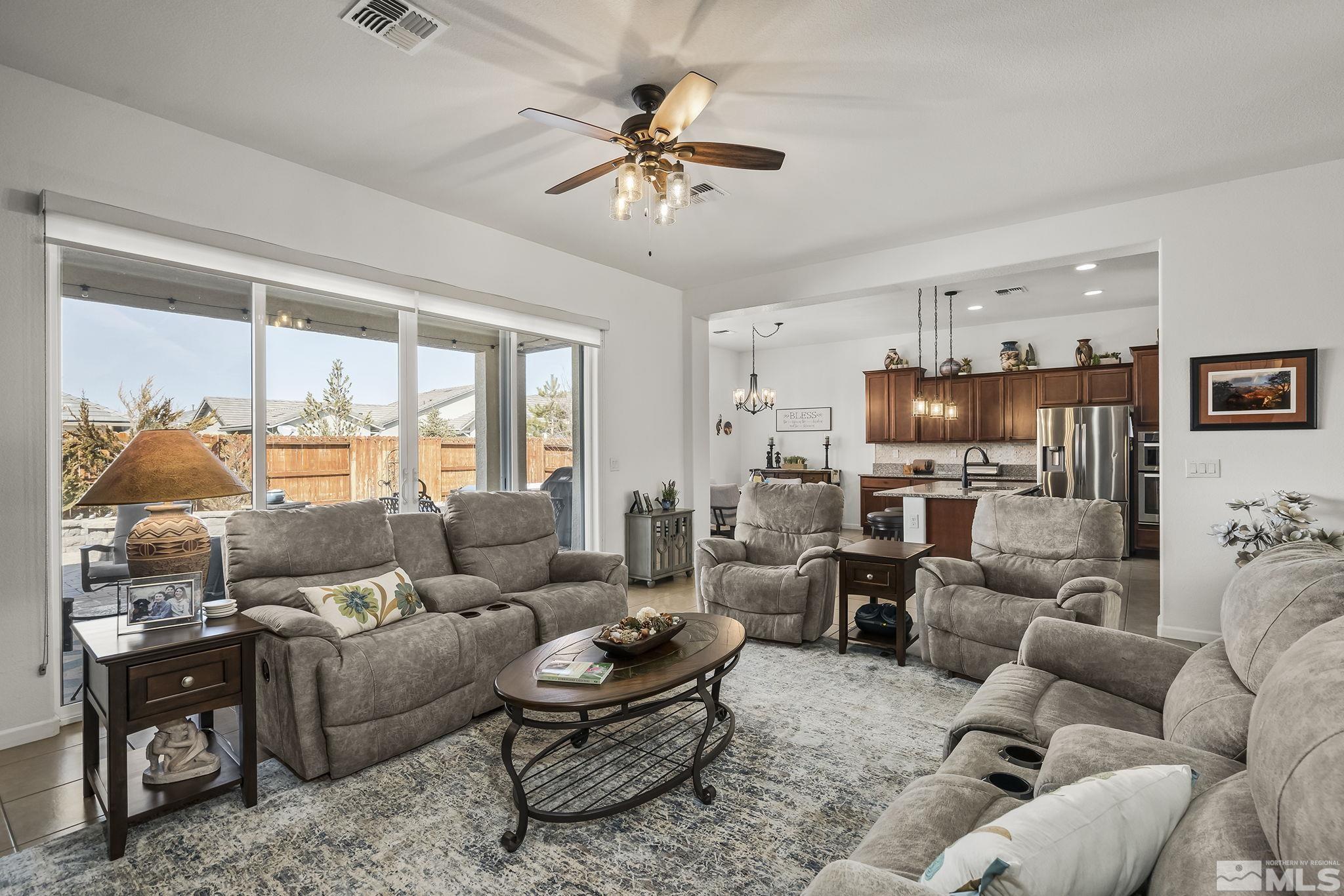 2215 Trakehner Lane Reno, NV 89521 - Photo 4 of 23 a living room with furniture ceiling fan and a floor to ceiling window