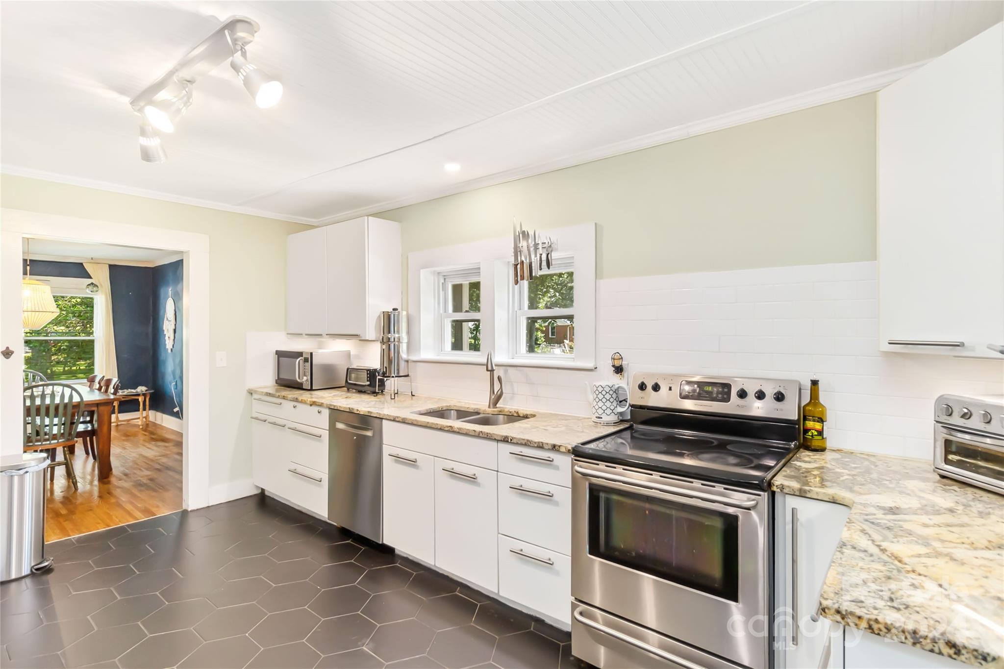 5500 Wilora Lake Road Charlotte, NC 28212 - Photo 11 of 32 a kitchen with a stove top oven sink and cabinets