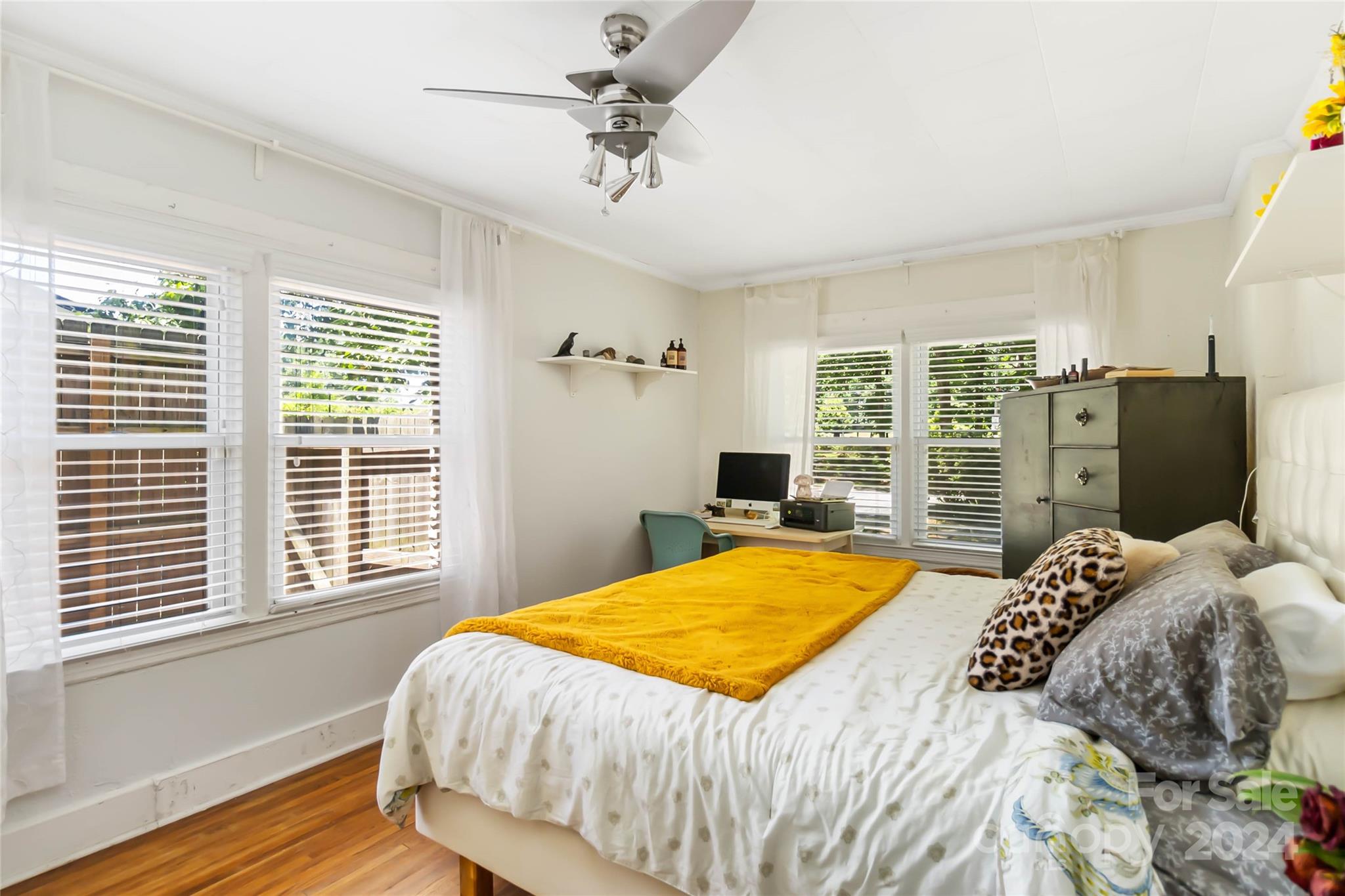 5500 Wilora Lake Road Charlotte, NC 28212 - Photo 16 of 32 a bedroom with a bed and a chandelier