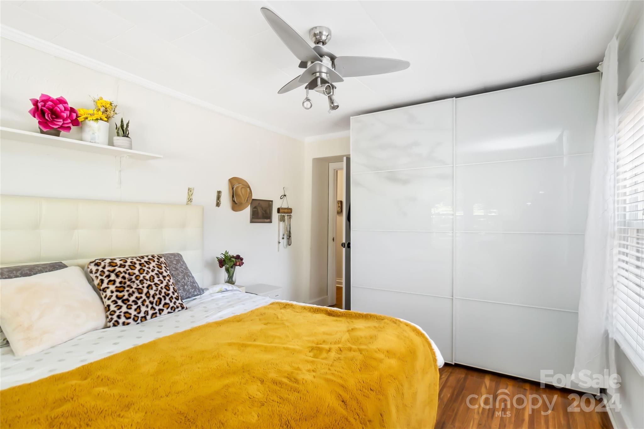 5500 Wilora Lake Road Charlotte, NC 28212 - Photo 17 of 32 a bedroom with a bed and a chandelier
