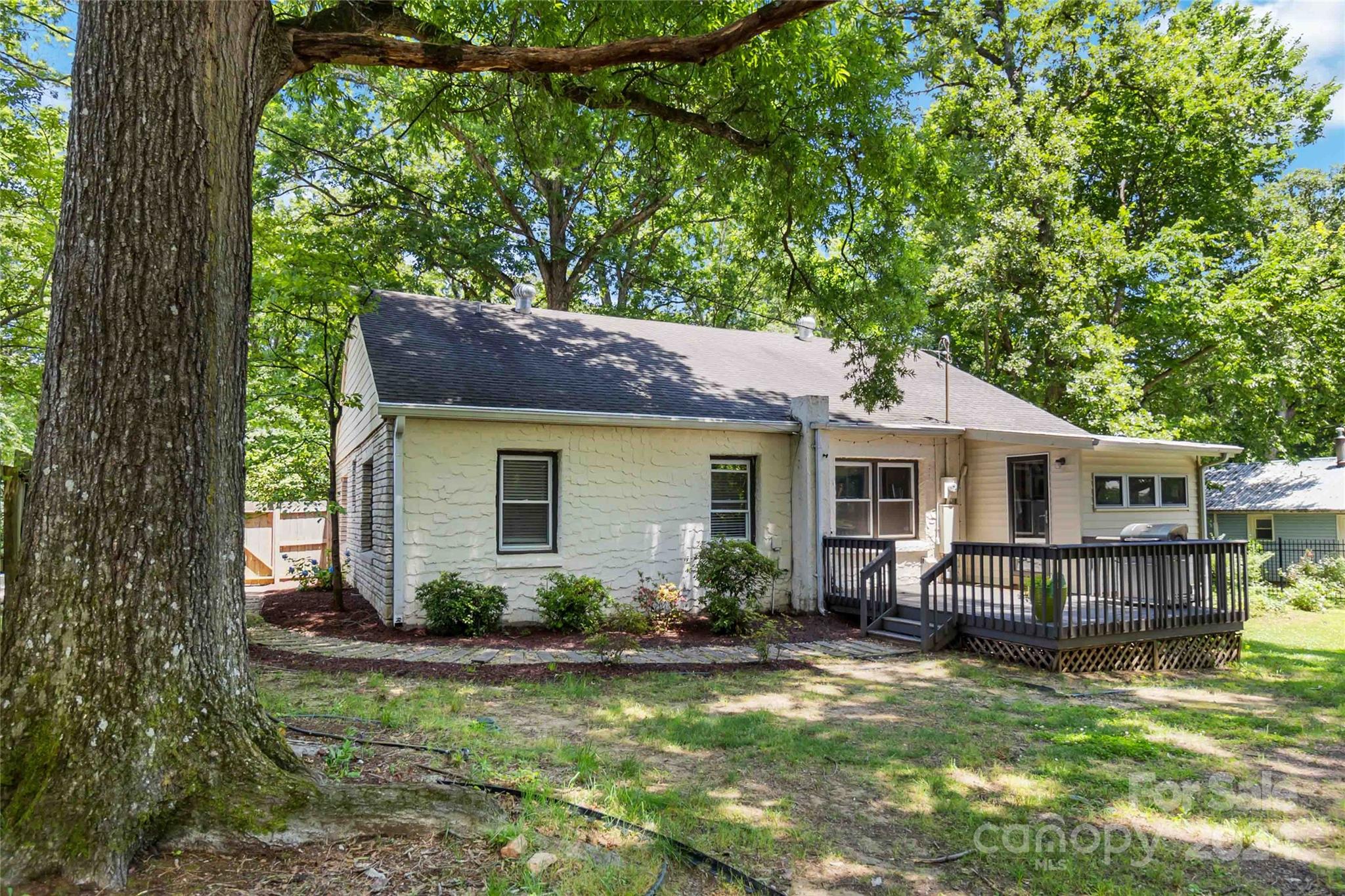 5500 Wilora Lake Road Charlotte, NC 28212 - Photo 24 of 32 a view of a house with a yard chairs and potted plants