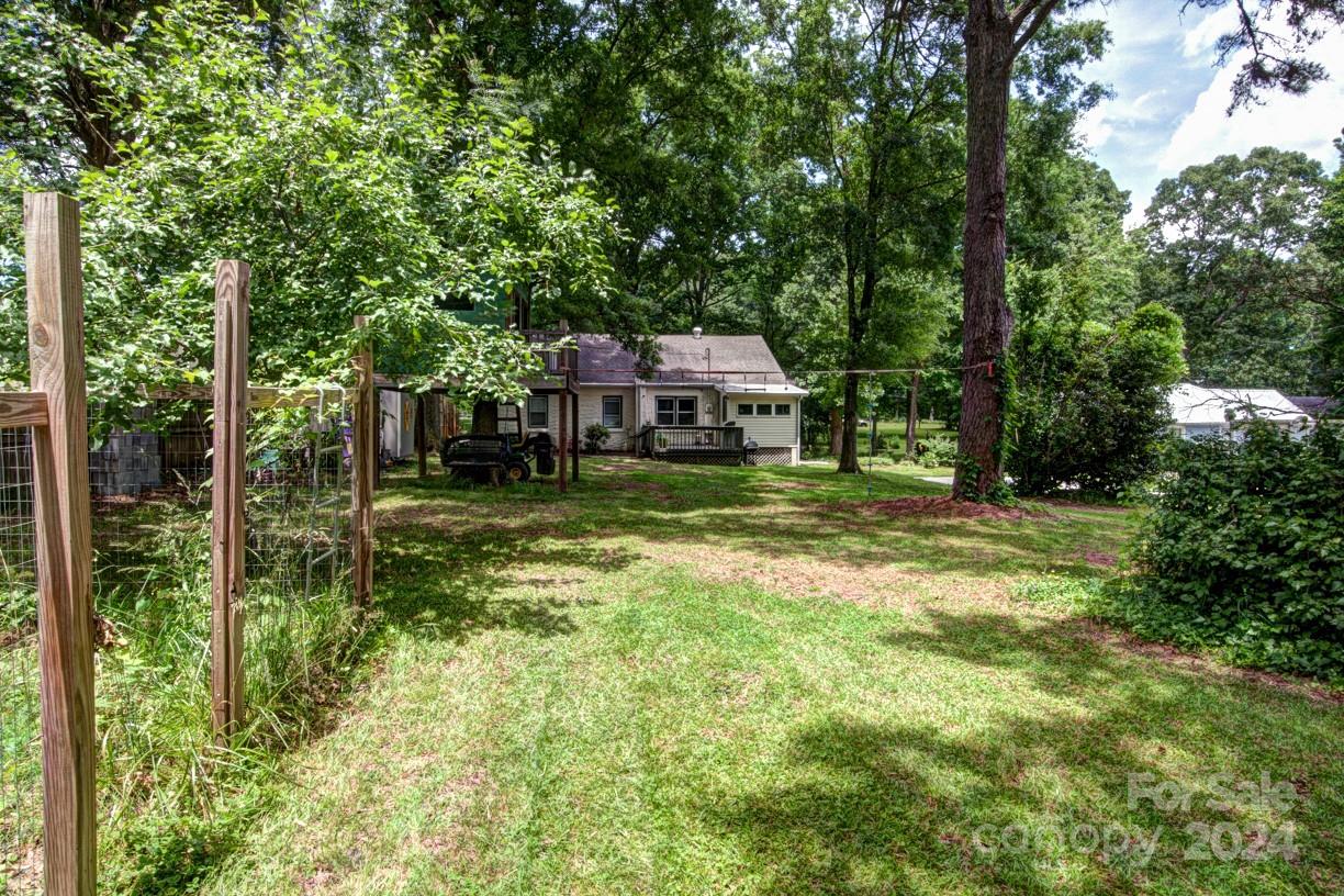 5500 Wilora Lake Road Charlotte, NC 28212 - Photo 30 of 32 a view of a house with a big yard and large trees