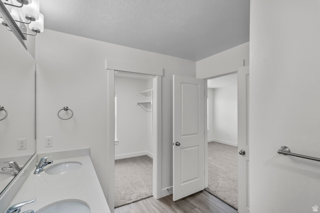 3014 South 265th Street West Logan, UT 84321 - Photo 25 of 25 Double vanity with integrated sinks and chrome fixtures, illuminated by a multi-bulb light fixture