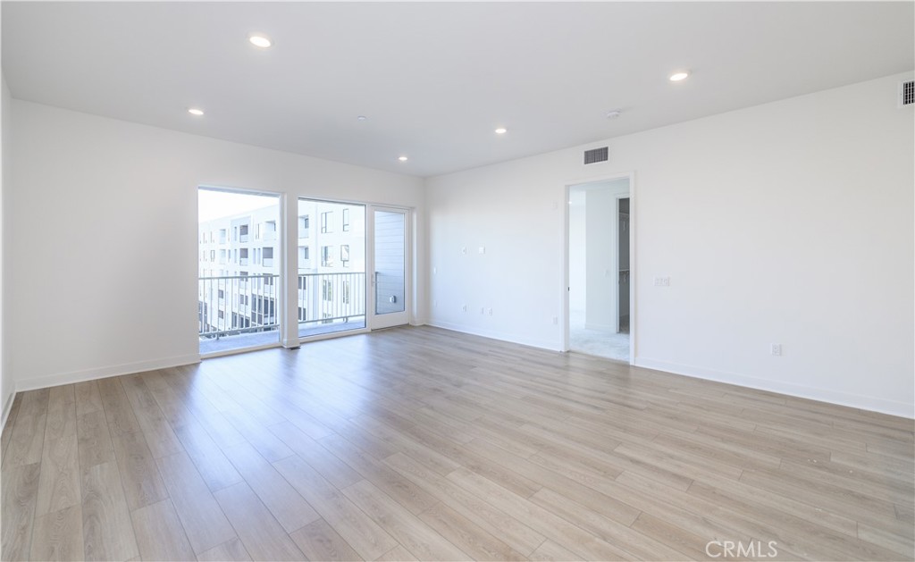 3608 Rivington Irvine, CA 92612 - Photo 10 of 74 a view of an empty room with wooden floor and a window