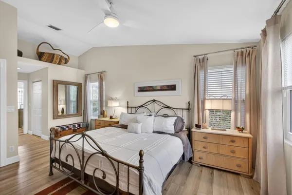 a bedroom with a bed and wooden floor