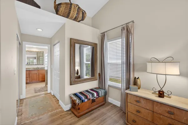 a spacious bedroom with a bed and a flat screen tv