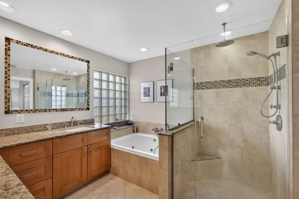 a bathroom with a bathtub and a shower