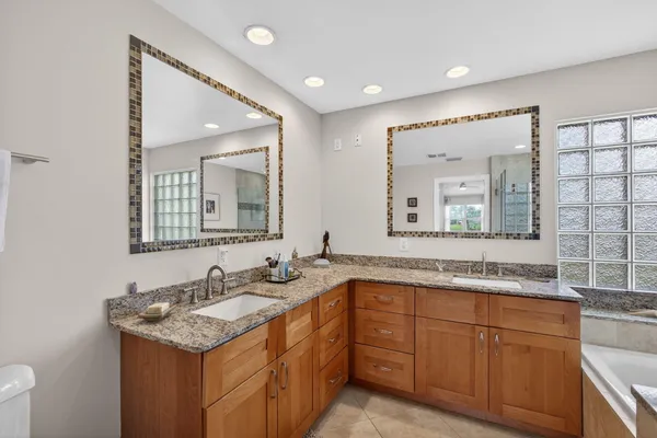 a spacious bedroom with a bed and a ceiling fan