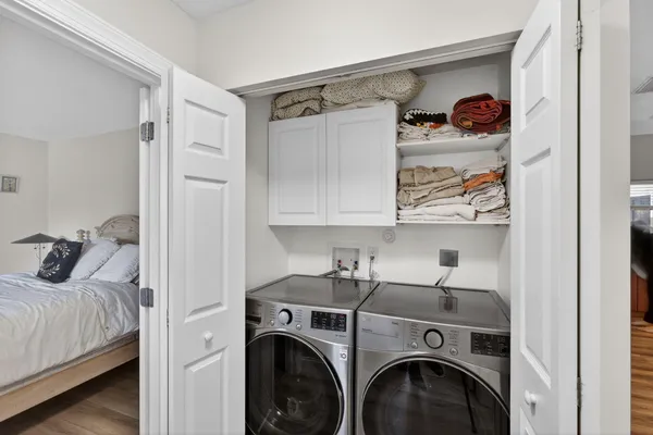 a bedroom with a bed and a chandelier