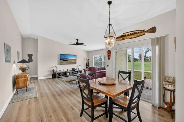 a view of a dining room with furniture wooden floor and chandelier
