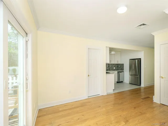 a view of a kitchen with a sink and a refrigerator