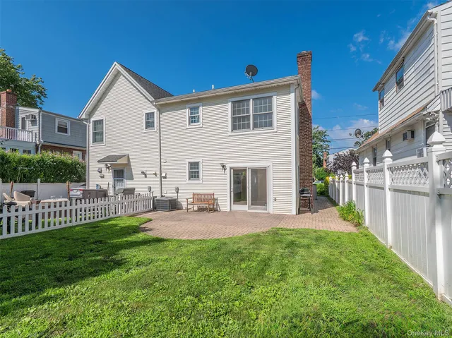 a view of a house with a yard and sitting area