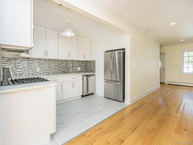 a kitchen with stainless steel appliances granite countertop a refrigerator and a stove