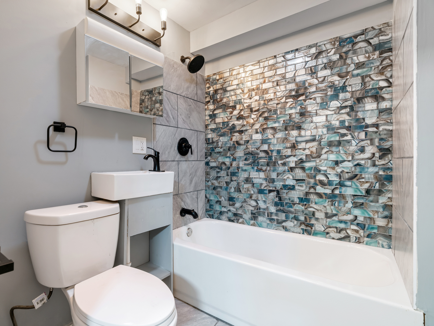 5431 South Indiana Avenue, Unit G Chicago, IL 60615 - Photo 7 of 10 a white toilet sitting next to a bath tub