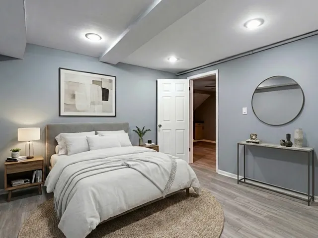 a bedroom with a bed and a chandelier