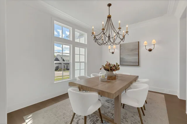 a living room with furniture a fireplace and a chandelier