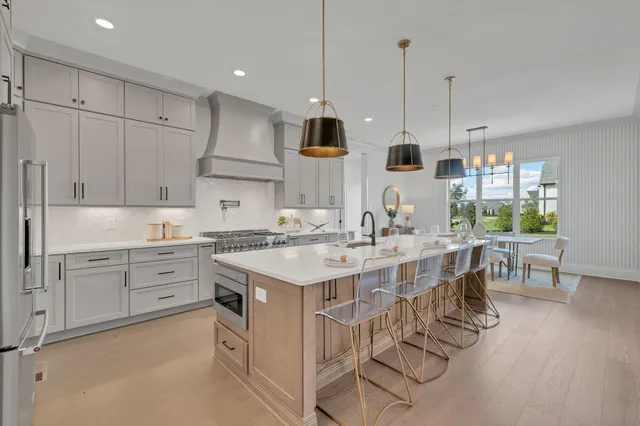 a spacious bedroom with a bed and a chandelier