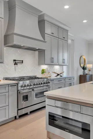 a bathroom with a tub a sink and glass door shower