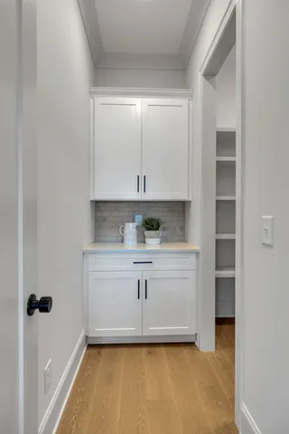 a kitchen with white cabinets and white appliances