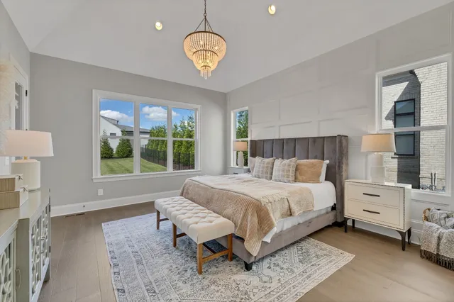 a view of a room with a chandelier fan and windows