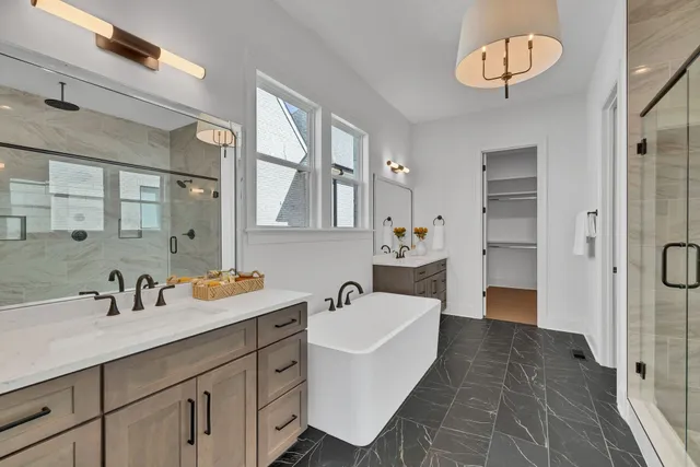 a bathroom with a sink shower and a mirror