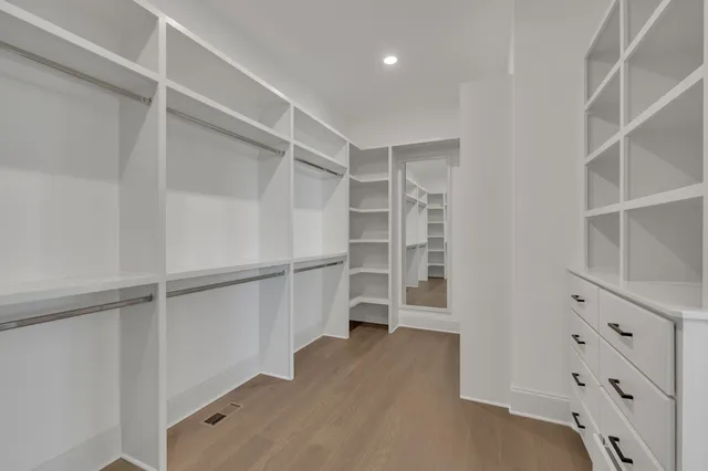 a bathroom with a bathtub shower sink vanity mirror and toilet