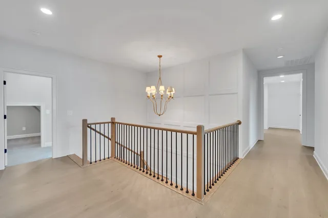 an aerial view of a house with a garden and lake view