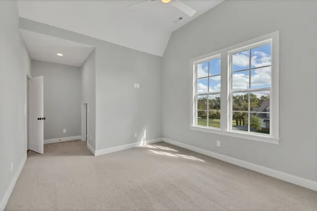 an aerial view of a house with a garden and lake view