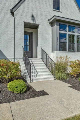 a view of a dining room with furniture wooden floor and chandelier