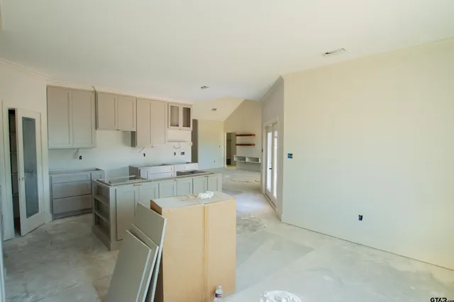 a kitchen with cabinets and a refrigerator