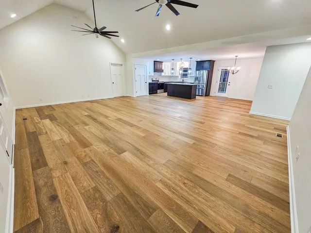 a view of a kitchen with a sink and wooden floor